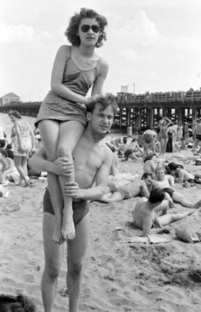 Reginald Marsh, [Man carrying woman on shoulders at Coney Island beach.], ca. 1938, Museum of the City of New York. © 2012 Estate of Reginald Marsh / Art Students League, New York / Artists Rights Society (ARS), New York
