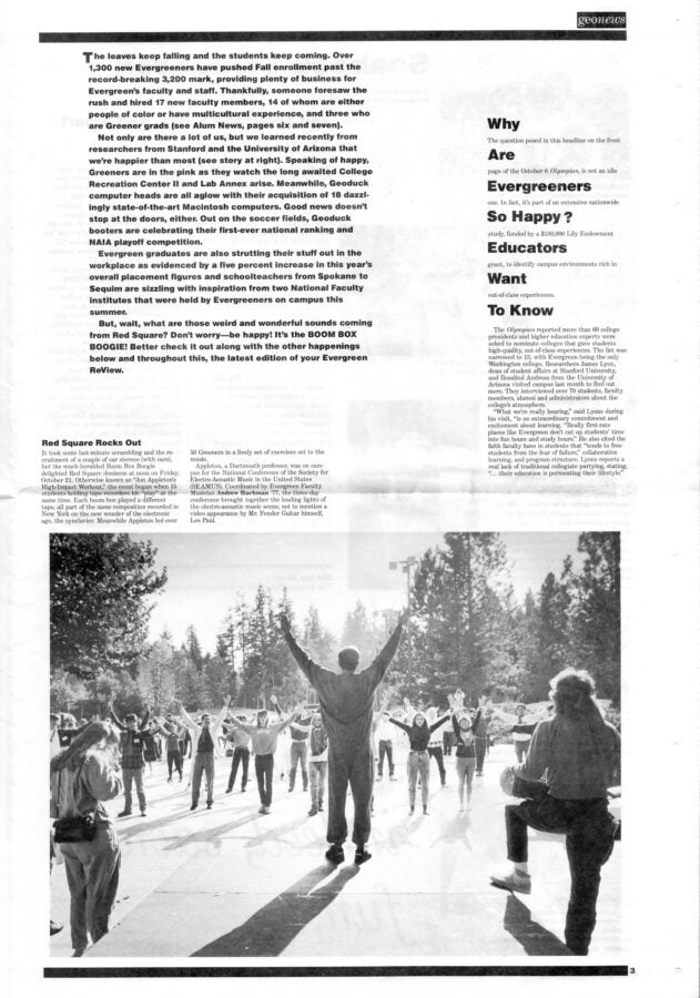 Black-and-white photo of students gathered outdoors with arms raised in a circle, surrounded by trees and campus buildings.