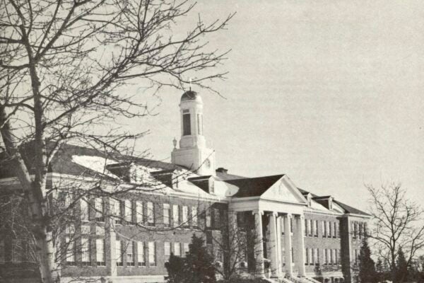 Black-and-white cover of Alumnus, published by Siena College (March 1967), featuring a winter view of a campus building with columns and a central cupola, surrounded by bare trees and snow.